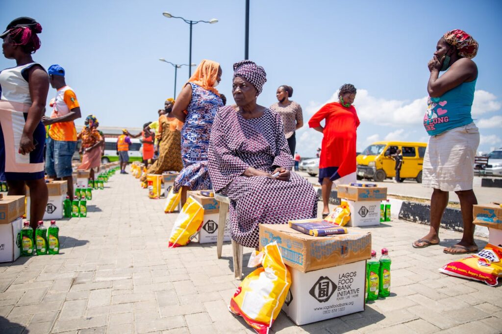 pexels-photo-8060300 A group of women receiving aid packages from Lagos Food Bank on a sunny day.